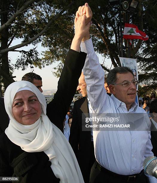 Lebanese Prime Minister Fuad Siniora and Education Minister Bahiya Hariri raise their arms in triumph during a celebration rally at the latter's...