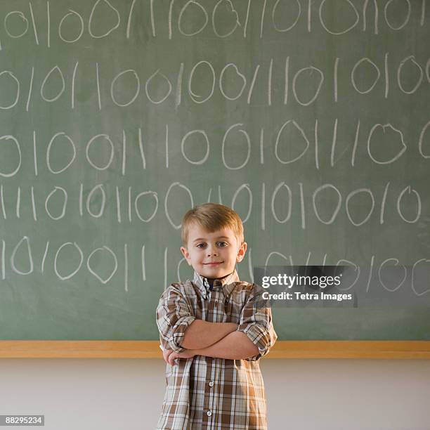 boy writing binary code on blackboard - confused writing ストックフォトと画像