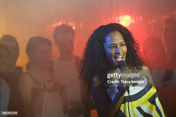 woman singing karaoke - karaoke stock pictures, royalty-free photos & images