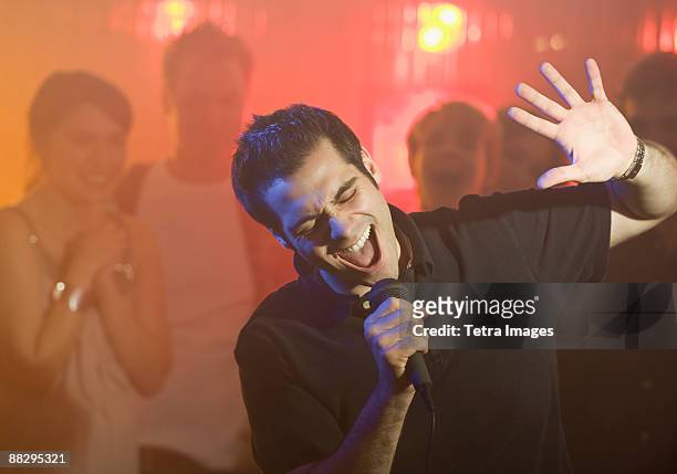 man singing karaoke - karaoke stock pictures, royalty-free photos & images