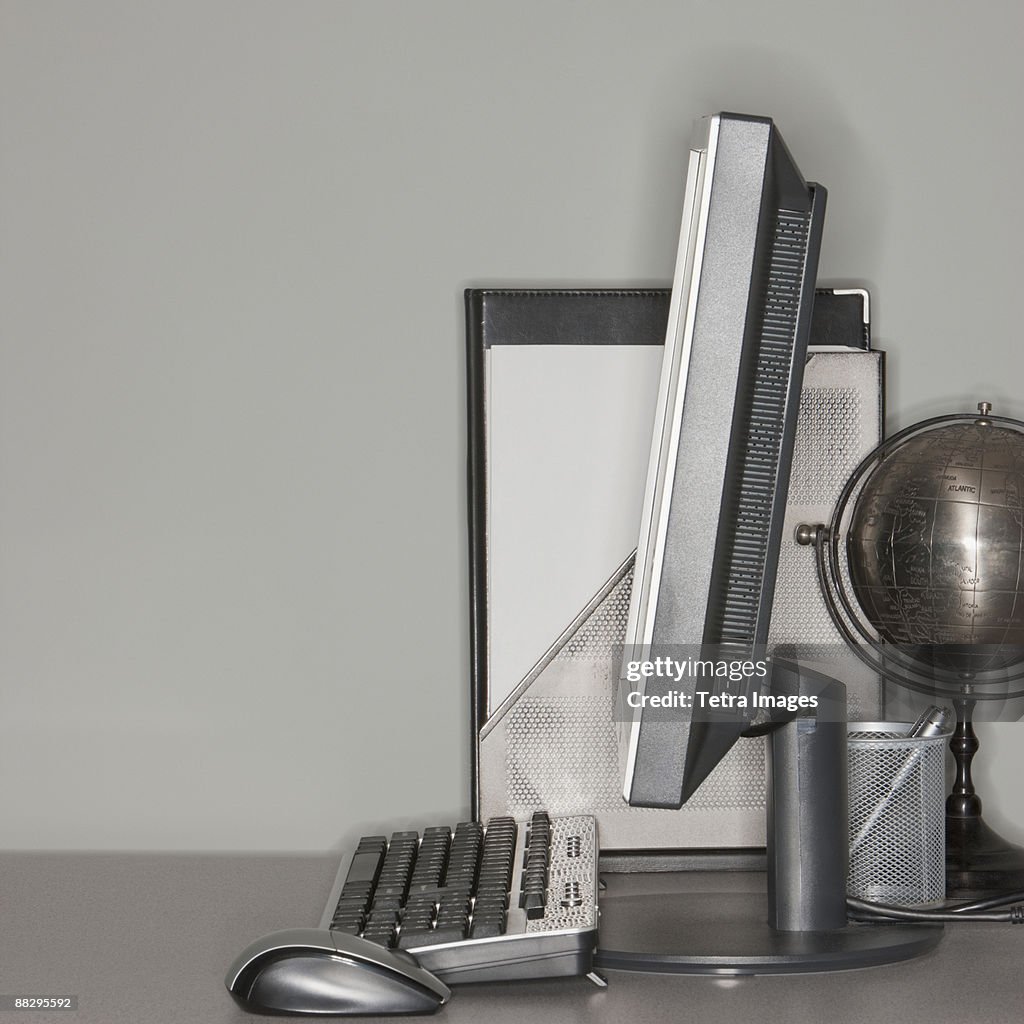 Computer and globe on office desk