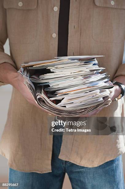 man holding stack of mail - junk mail stock pictures, royalty-free photos & images