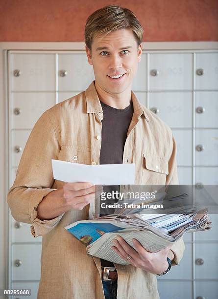 man sorting stack of mail - junk mail stock pictures, royalty-free photos & images