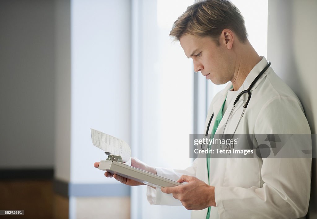 Doctor reading medical chart