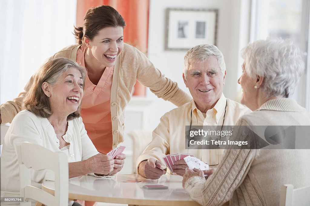 Senior adults playing cards