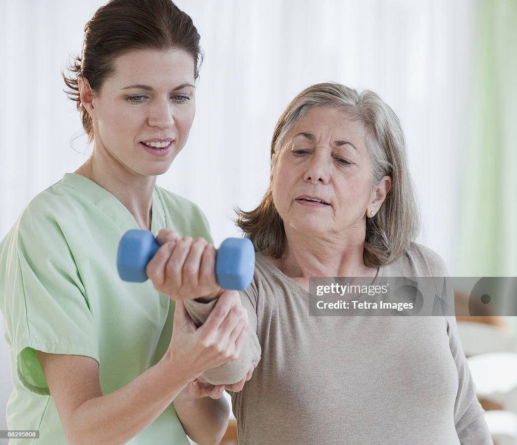 Physical therapist helping senior woman