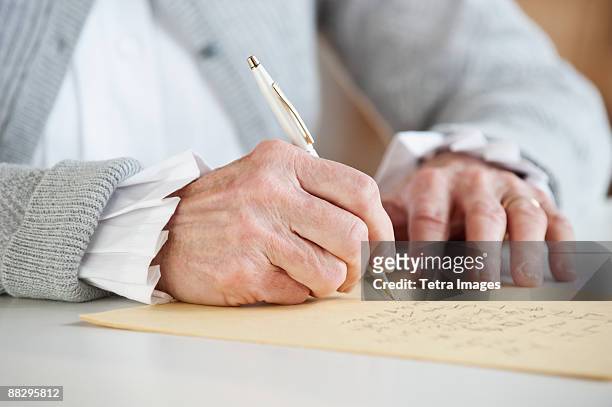 senior woman writing letter - answering stock pictures, royalty-free photos & images