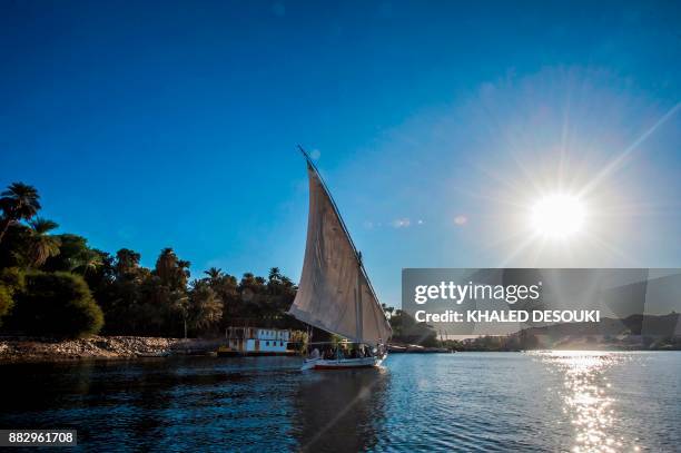 Picture taken on November 24, 2017 shows a felucca sailing down the Nile in the Egyptian city of Aswan, some 920 kilometres south of the capital...