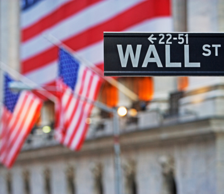 Wall Street sign and American flags