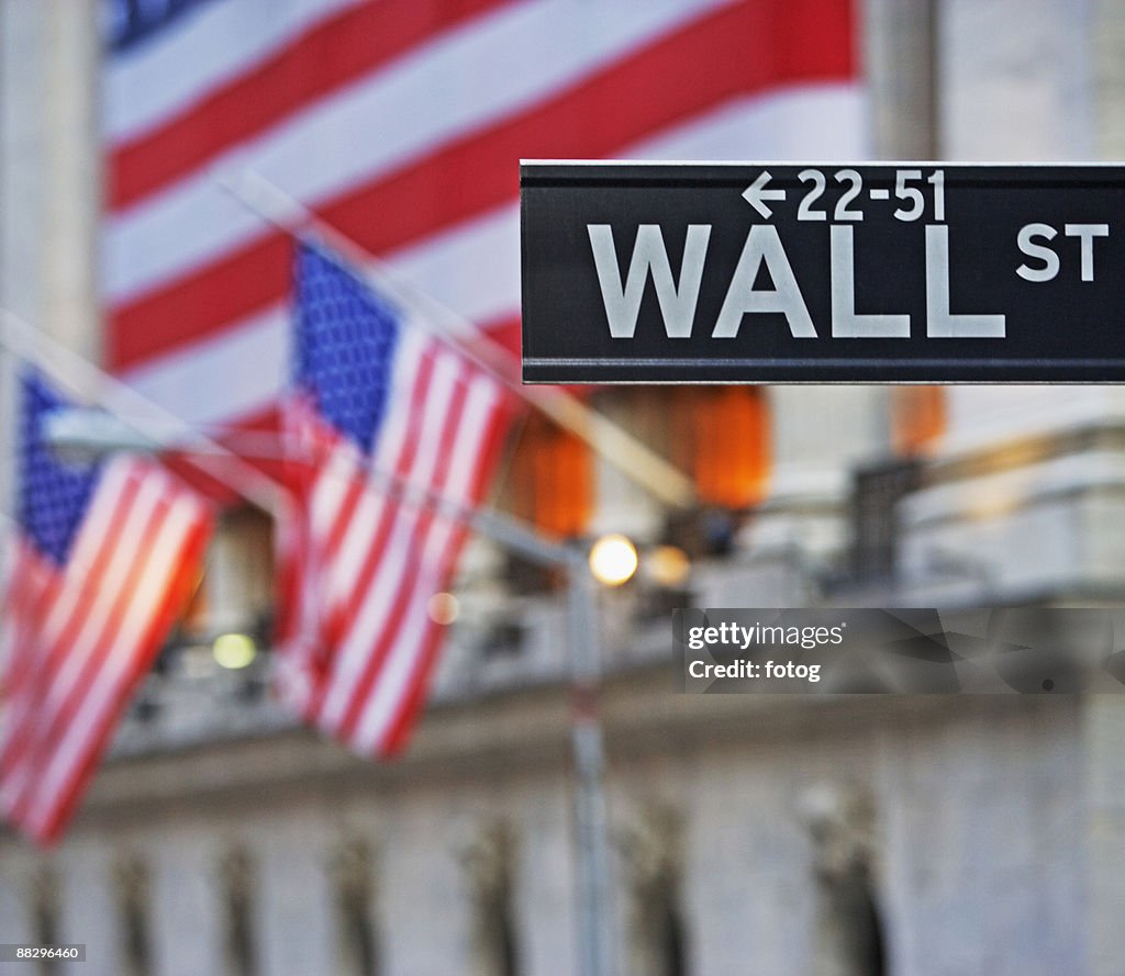 Wall Street sign and American flags