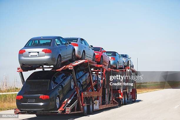 truck carrying new cars - car transporter stock-fotos und bilder