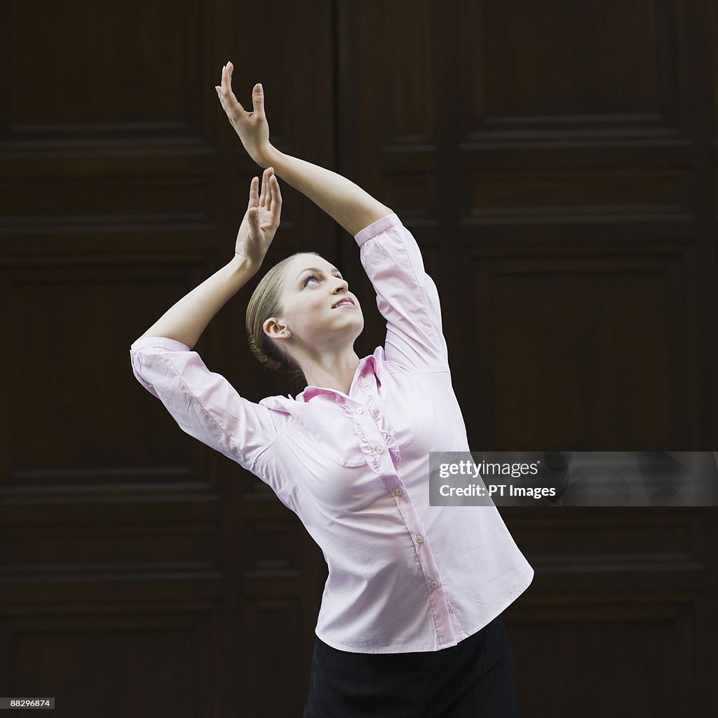 Businesswoman dancing in urban setting