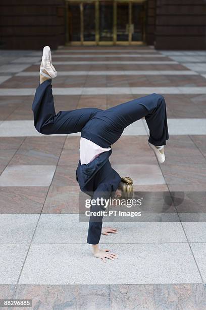 businesswoman dancing in urban setting - businesswoman handstand stock pictures, royalty-free photos & images