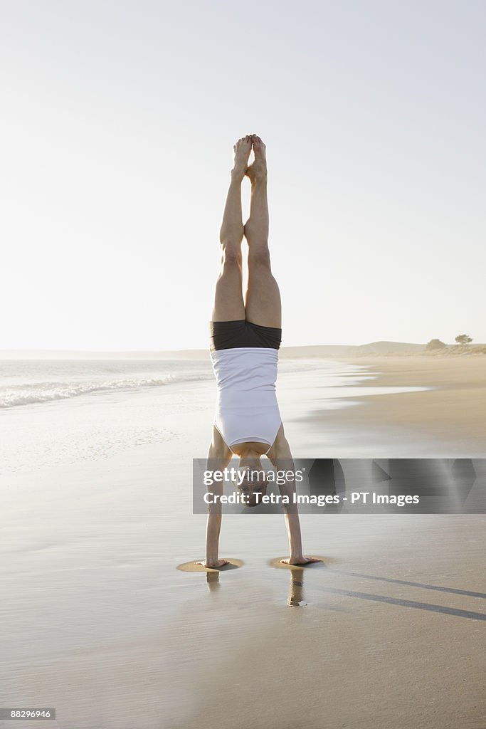 Woman doing yoga on beach