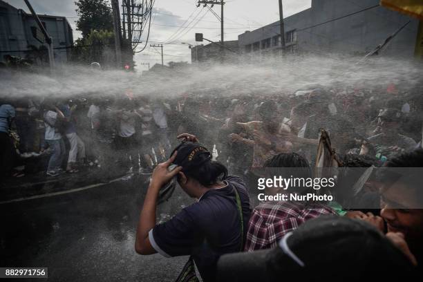 Police aim a water cannon at protesters during a demonstration against President Rodrigo Duterte in Manila, Philippines, November 30, 2017. Thousands...