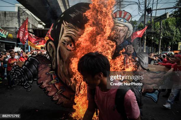Protesters burn an effigy of Philippine President Rodrigo Duterte and US President Donald Trump during a demonstration against President Rodrigo...