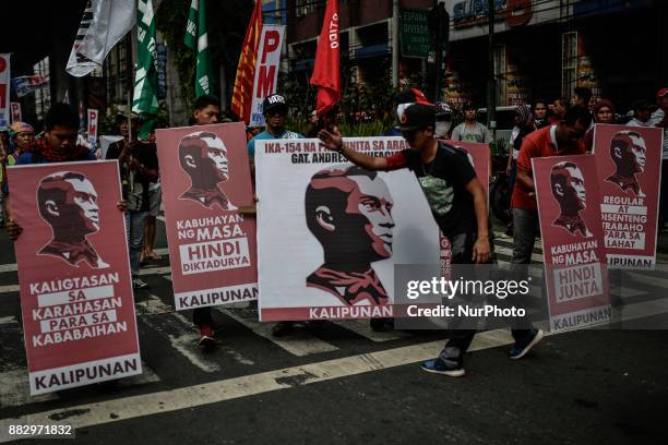 Protesters hold placards with portraits of Filipino revolutionary leader Andres Bonifacio during a demonstration against President Rodrigo Duterte in...