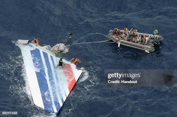 Handout image released on June 8, 2009 by the Brazilian Air Force shows crew members preparing to tow a part of the wreckage of a Air Bus A330-200...