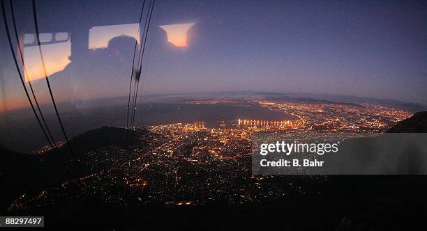 The lights of the city can be seen from the cable car descending from Table Mountain on March 15, 2009 in Cape Town, South Africa. South Africa will...
