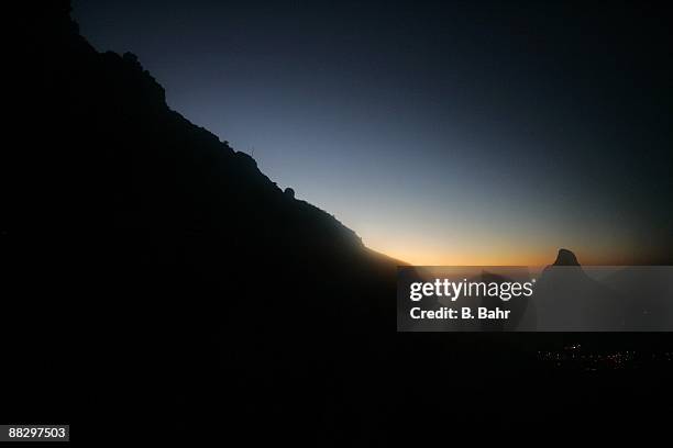 The last glow of sunset falls behind Table Mountain and Lions Head on March 15, 2009 in Cape Town, South Africa. South Africa will host the 2010 FIFA...