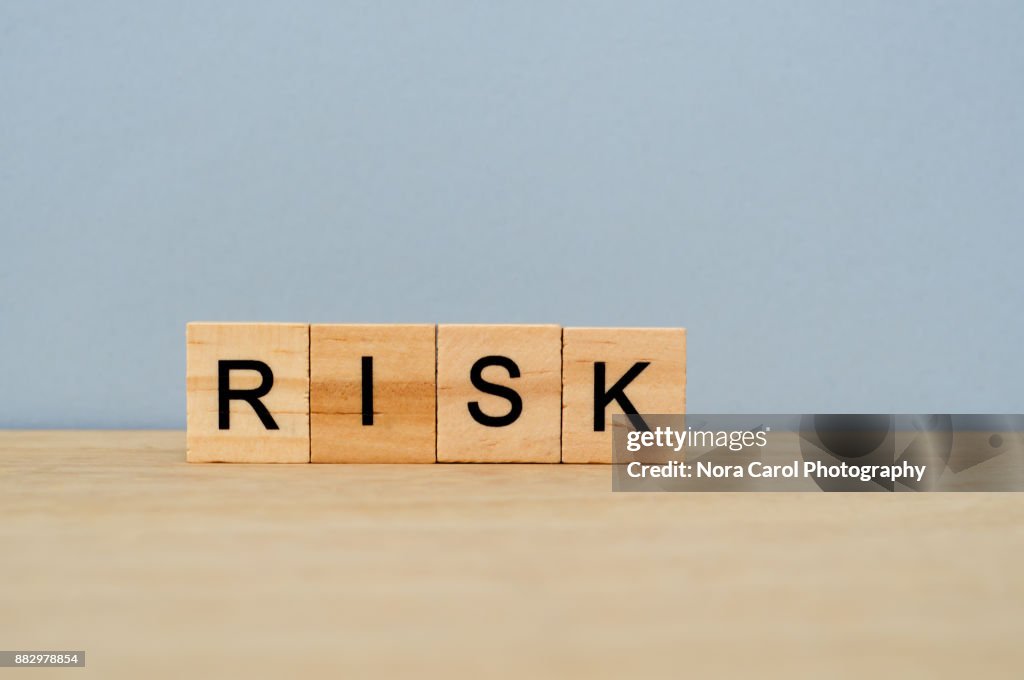 Risk Word on Wooden Tile Block