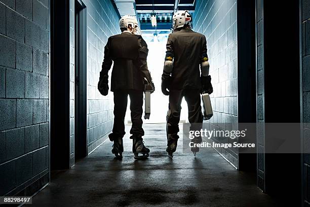 two businessmen wearing ice hockey uniforms - men's ice hockey stockfoto's en -beelden