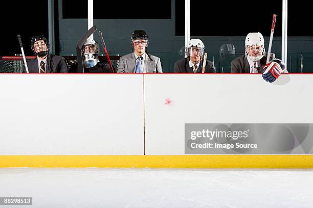 businessmen playing ice hockey - mens ice hockey fotografías e imágenes de stock