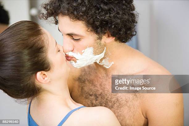 woman kissing man with shaving foam - couple and kiss and bathroom 個照片及圖片檔