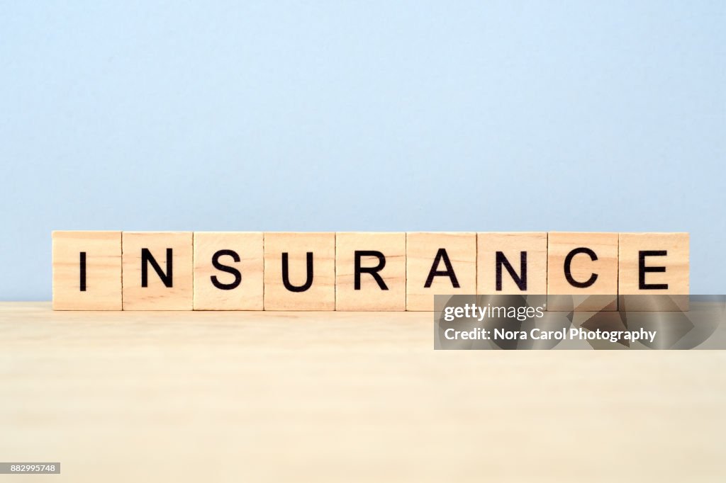 Insurance Word on Wooden Tile Block