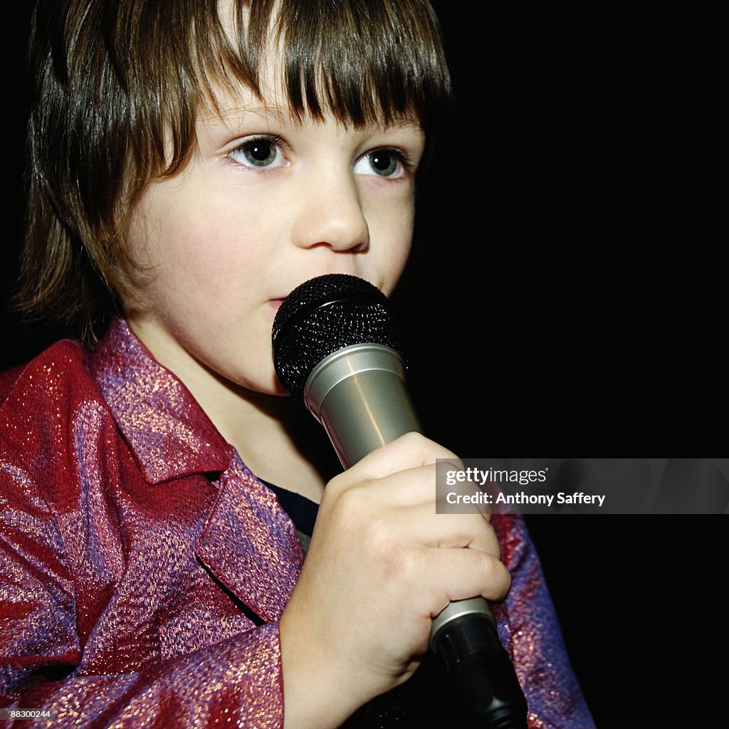 Boy performing with microphone