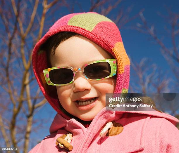 smiling girl wearing sunglasses - anthony saffery stock pictures, royalty-free photos & images