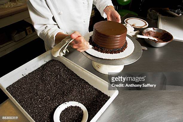 pastry chef decorating cake - anthony saffery stock pictures, royalty-free photos & images
