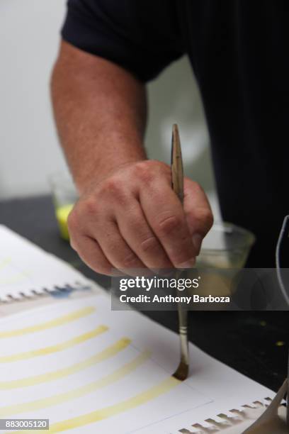 Close-up of American artist Mike Solomon's hand as he paints in his Long Island studio, East Hampton, New York, August 10, 2011.