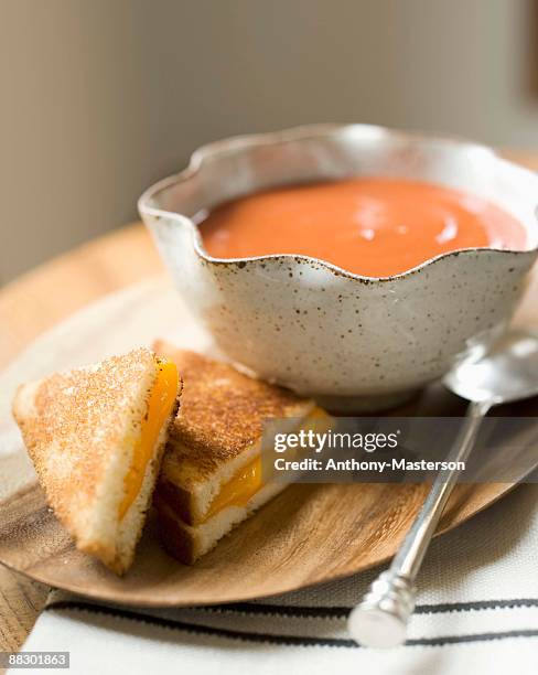 bowl of tomato soup and grilled cheese sandwich - anthony masterson stock-fotos und bilder