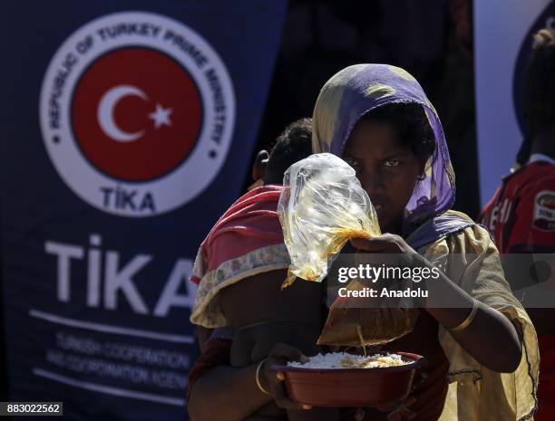 Rohingya woman, fled from oppression within ongoing military operations in Myanmars Rakhine state, receives food aid, provided by the Turkish...