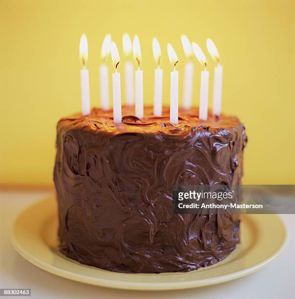 chocolate birthday cake with candles - anthony masterson stock-fotos und bilder
