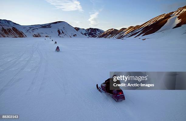 people on snowmobiles, landmannlaugar, iceland - langjokull stock pictures, royalty-free photos & images