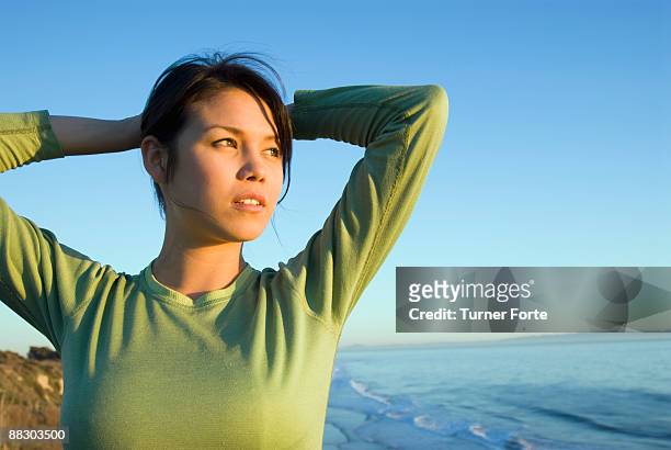 pensive woman by seashore - turner forte stockfoto's en -beelden