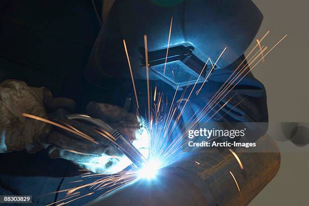 welder working on metal pipes - welder stock pictures, royalty-free photos & images