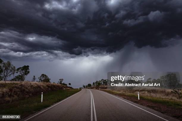 moody skies await - stormy clouds stock-fotos und bilder