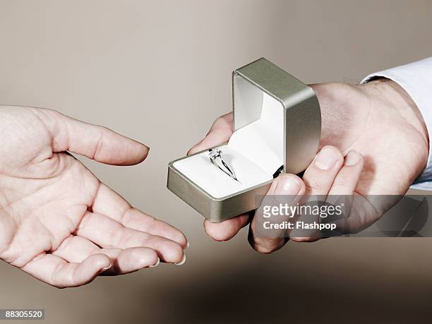 hands of people exchanging ring - schmuckschatulle stock-fotos und bilder