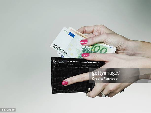 hands with billfold and money - portafoglio foto e immagini stock