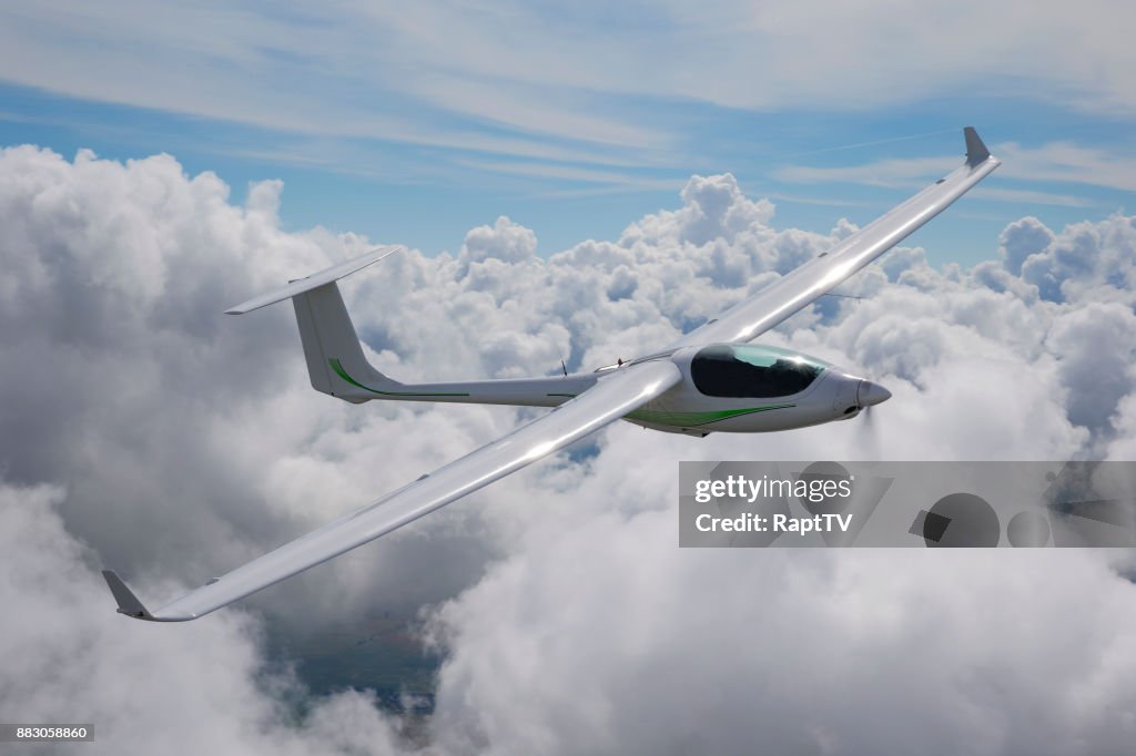 A Motor Glider Using it's Engine to gain Altitude over the Clouds.