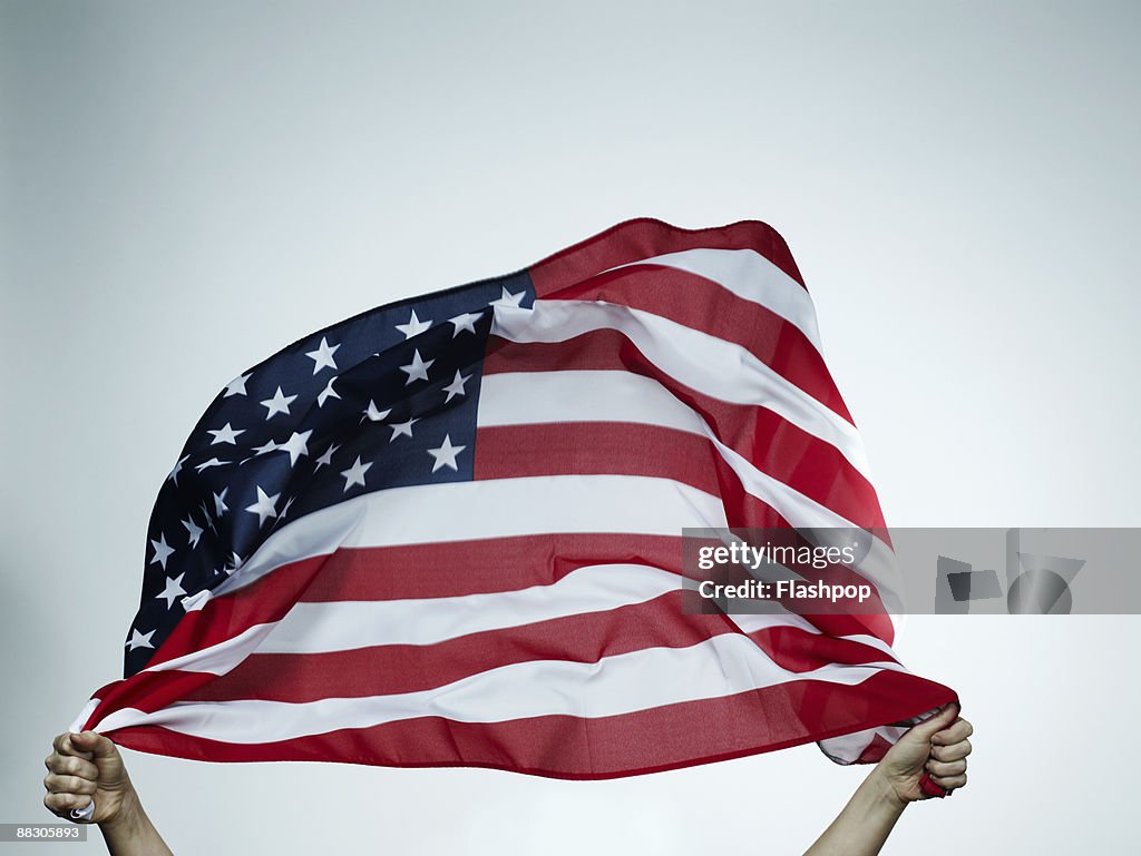Hands holding American flag