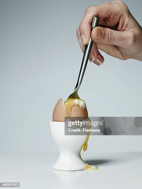 hand with spoon in soft-boiled egg - crack spoon stock pictures, royalty-free photos & images