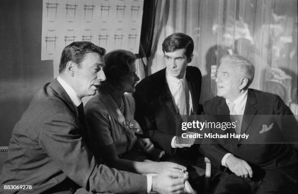 Actors Yves Montand , Ingrid Bergman , Anthony Perkins with Russian-born American filmmaker Anatole Litvak on the set of romantic drama film 'Goodbye...