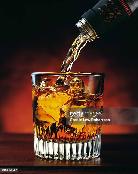 pouring glass of whiskey - bourbon whisky stockfoto's en -beelden