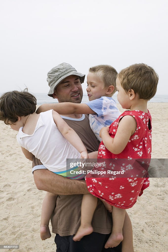 Father holding children