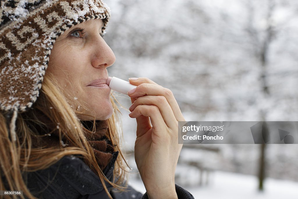Woman using lip balm
