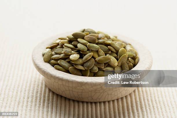bowl of pepitas - pumpkin seed stock pictures, royalty-free photos & images